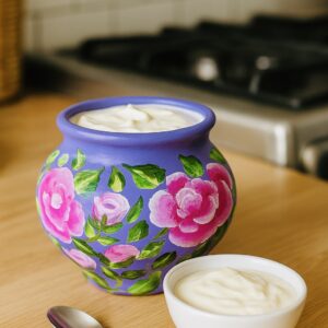 Pink Peony hand-painted terracotta pot with pink floral artwork on a lavender background.