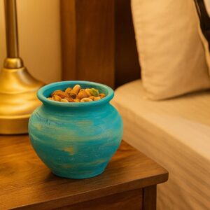 Hand-painted turquoise terracotta pot styled as a decorative bowl and storage piece for home décor