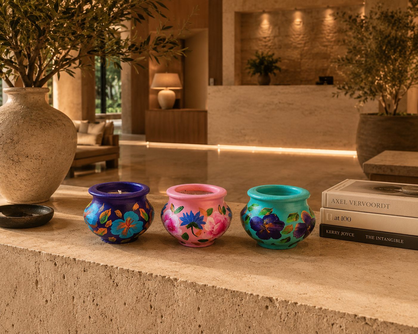 Set of three hand-painted terracotta candle pots in purple pink and turquoise floral designs