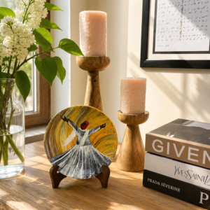 Hand-painted terracotta plate featuring a whirling dervish in gold and white tones on a warm golden background
