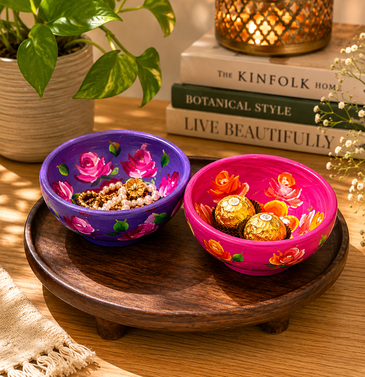 Hand-painted floral terracotta trinket bowls in pink and purple displayed on a wooden tray