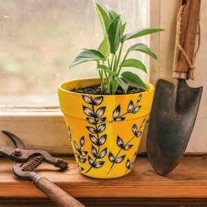 Hand-painted yellow terracotta planter featuring black and white leafy botanical patterns